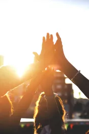 Happy friends at the rooftop doing high five