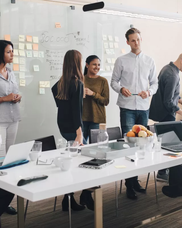Multi-ethnic business coworkers discussing during meeting in board room at office