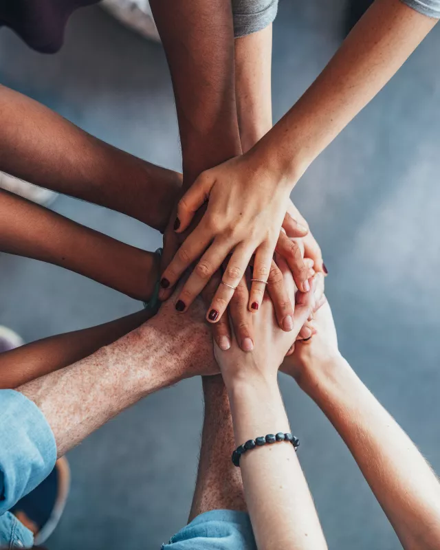 Stack of hands showing unity