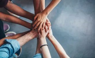 Stack of hands showing unity
