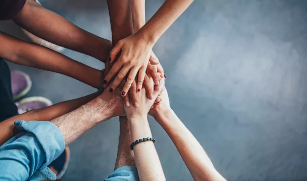 Stack of hands showing unity