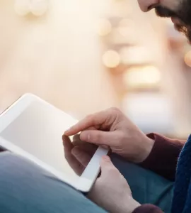 Man arbeitet an Tablet, Straße im Hintergrund