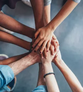 Stack of hands showing unity