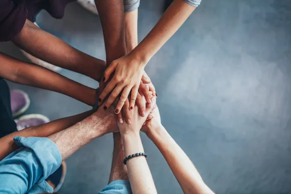 Stack of hands showing unity