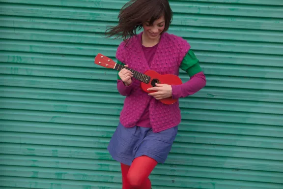 Young woman playing ukulele